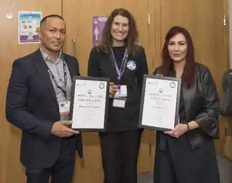 Sherwin Criseno (L) and Lisa Shepherd (R) receiving their awards from XX